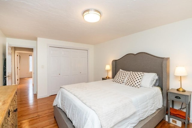 10 Grove Sq Unit 10, Randolph, MA 02368 - bedroom featuring light wood finished floors, a closet, and baseboards