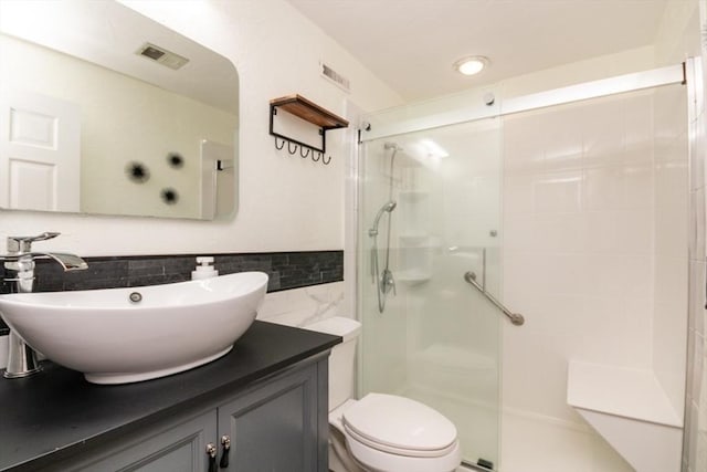 10 Grove Sq Unit 10, Randolph, MA 02368 - bathroom featuring tile walls, a shower stall, vanity, toilet, and wainscoting
