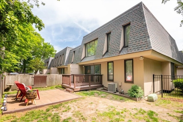 10 Grove Sq Unit 10, Randolph, MA 02368 - back of house with a shingled roof, mansard roof, a fenced backyard, and a wooden deck