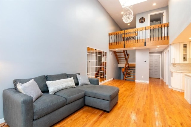 10 Grove Sq Unit 10, Randolph, MA 02368 - living area with a towering ceiling, light wood finished floors, recessed lighting, stairway, and baseboards