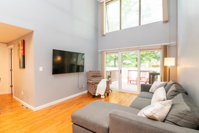 10 Grove Sq Unit 10, Randolph, MA 02368 - living room with wood finished floors, a high ceiling, and baseboards