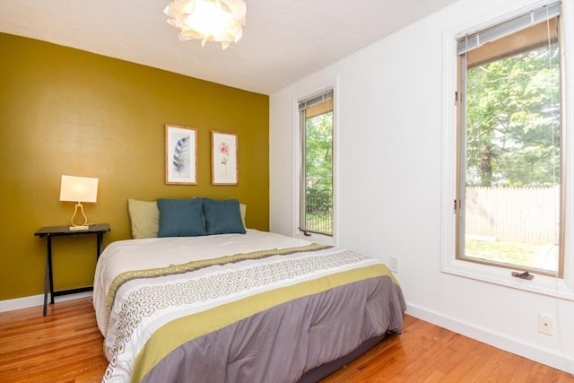 10 Grove Sq Unit 10, Randolph, MA 02368 - bedroom with multiple windows, wood finished floors, and baseboards