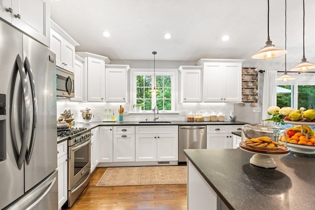 16 Lochmont St, North Attleboro, MA 02760 - kitchen with appliances with stainless steel finishes, dark countertops, recessed lighting, and backsplash