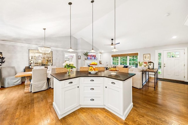 16 Lochmont St, North Attleboro, MA 02760 - kitchen with open floor plan, dark countertops, light wood finished floors, a kitchen island, and vaulted ceiling