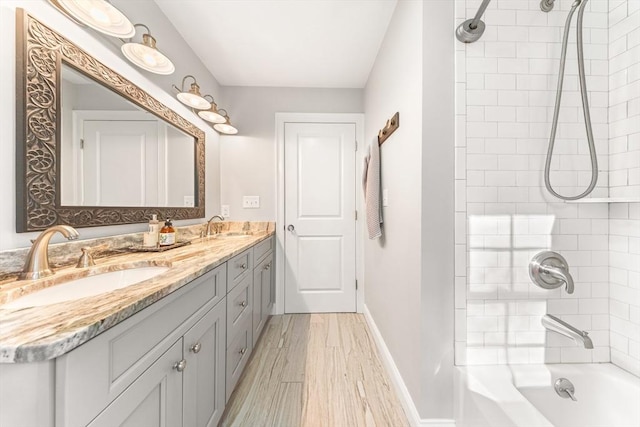 16 Lochmont St, North Attleboro, MA 02760 - bathroom featuring double vanity, washtub / shower combination, and wood finished floors