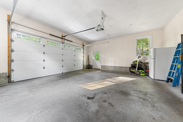16 Lochmont St, North Attleboro, MA 02760 - garage with a garage door opener and freestanding refrigerator