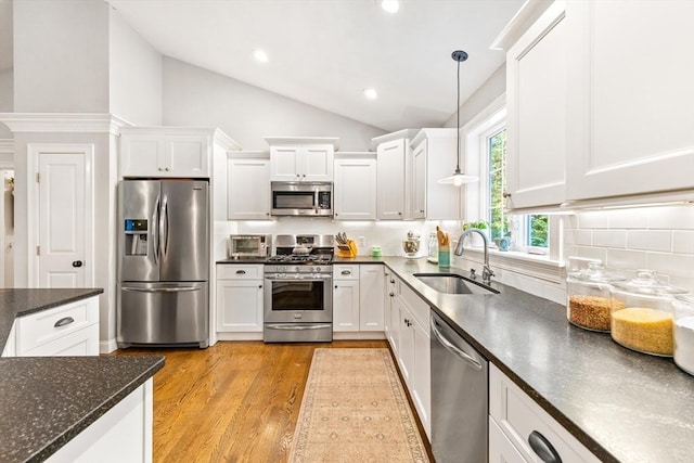 16 Lochmont St, North Attleboro, MA 02760 - kitchen featuring appliances with stainless steel finishes, lofted ceiling, white cabinets, backsplash, and light wood finished floors