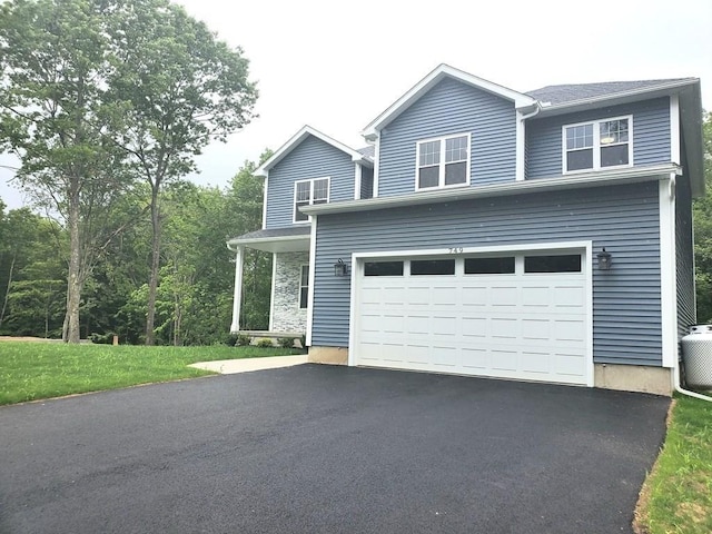 749 W St, Ludlow, MA 01056 - traditional-style house featuring asphalt driveway and a garage