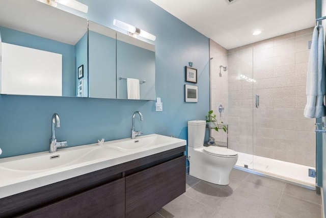 bathroom featuring tile patterned flooring, vanity, an enclosed shower, and toilet