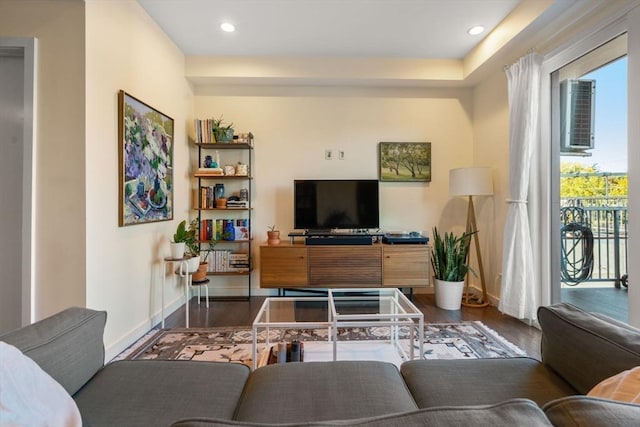 living room featuring dark hardwood / wood-style flooring and a healthy amount of sunlight