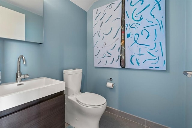 bathroom featuring tile patterned flooring, vanity, and toilet