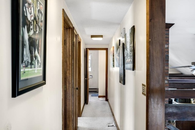 62 Monomoy Cir, Barnstable, MA 02632 - hallway featuring a baseboard radiator, carpet, and baseboards