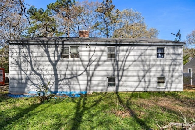 62 Monomoy Cir, Barnstable, MA 02632 - view of home's exterior featuring a chimney and a yard