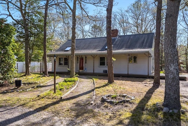 62 Monomoy Cir, Barnstable, MA 02632 - ranch-style house with fence, a chimney, and covered porch