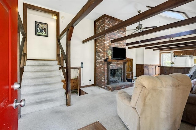 62 Monomoy Cir, Barnstable, MA 02632 - carpeted living area with a ceiling fan, stairway, and a fireplace