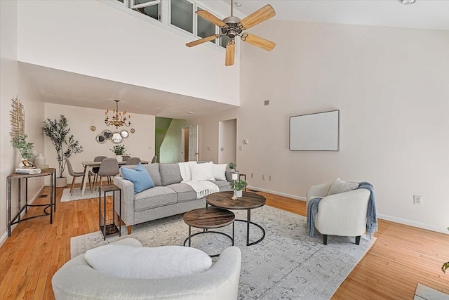 9 Edward Dr Unit 9, Grafton, MA 01536 - living area featuring a high ceiling, a chandelier, light wood-style flooring, baseboards, and a ceiling fan
