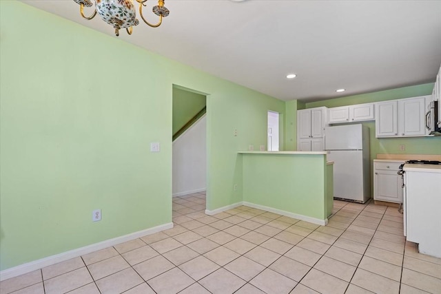 9 Edward Dr Unit 9, Grafton, MA 01536 - kitchen with freestanding refrigerator, white cabinets, a chandelier, light countertops, and recessed lighting