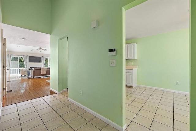 9 Edward Dr Unit 9, Grafton, MA 01536 - spare room featuring light tile patterned floors, ceiling fan, baseboards, and a towering ceiling