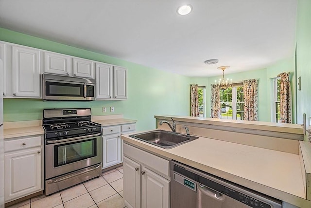 9 Edward Dr Unit 9, Grafton, MA 01536 - kitchen featuring stainless steel appliances, a sink, a chandelier, white cabinetry, and light countertops