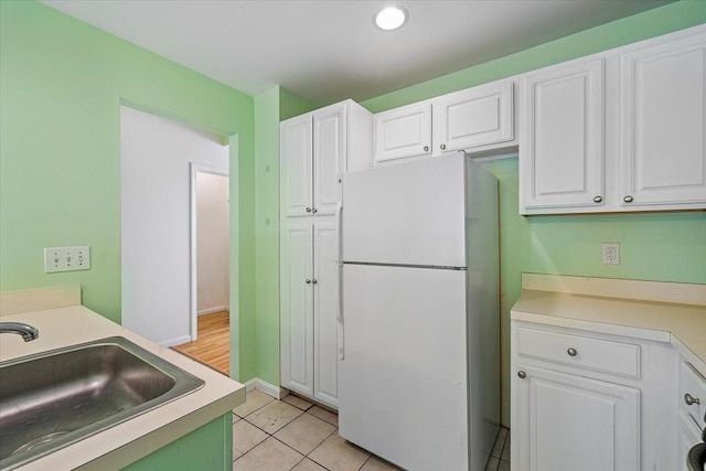 9 Edward Dr Unit 9, Grafton, MA 01536 - kitchen featuring freestanding refrigerator, a sink, white cabinets, light countertops, and recessed lighting