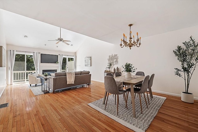 9 Edward Dr Unit 9, Grafton, MA 01536 - dining area with light wood-style flooring, a chandelier, baseboards, a glass covered fireplace, and lofted ceiling