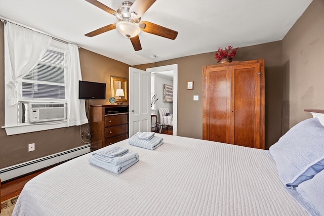 bedroom with ceiling fan, cooling unit, a baseboard radiator, and hardwood / wood-style floors