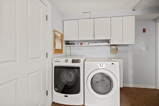 washroom with dark carpet, cabinets, and independent washer and dryer