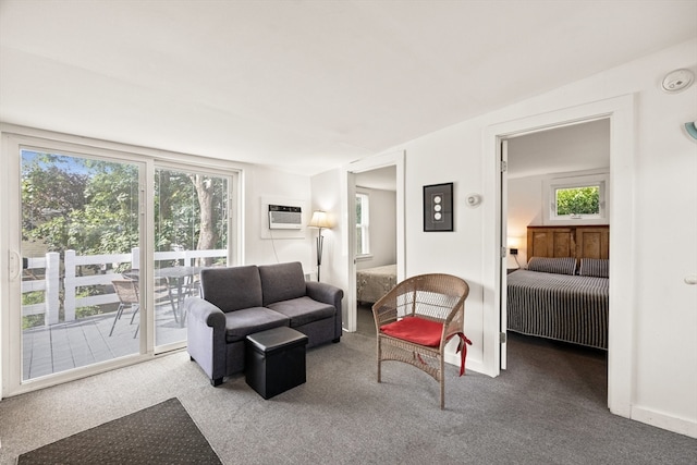 living room with a wall unit AC and carpet flooring