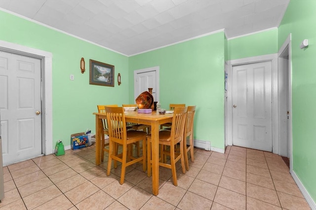 tiled dining space featuring crown molding