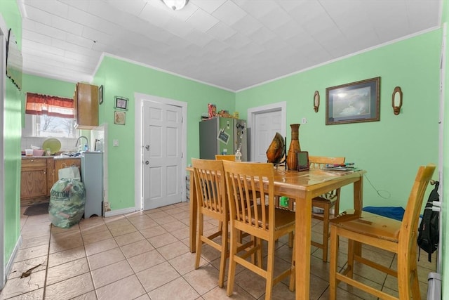 tiled dining space featuring ornamental molding