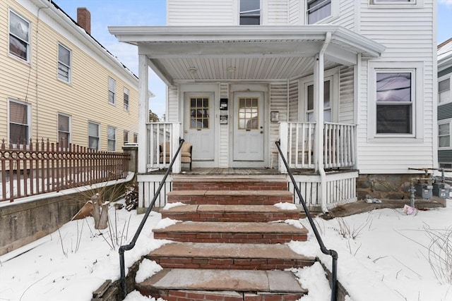 view of snow covered property entrance