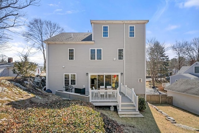 back of property with fence, outdoor lounge area, and a deck