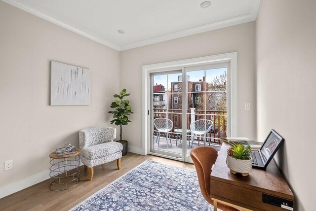 living area with hardwood / wood-style floors and ornamental molding