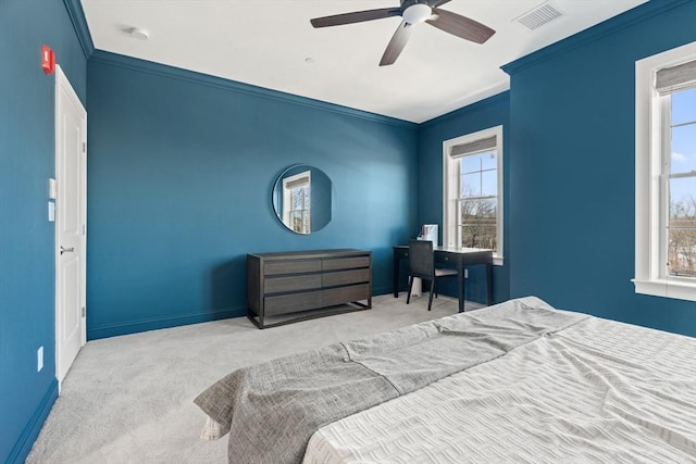 carpeted bedroom with crown molding, baseboards, visible vents, and ceiling fan