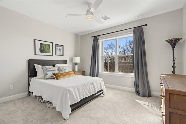 bedroom with visible vents, baseboards, light colored carpet, and ceiling fan