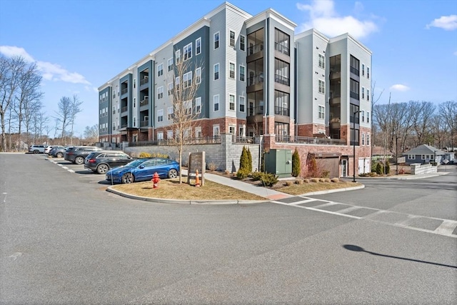 view of building exterior with uncovered parking