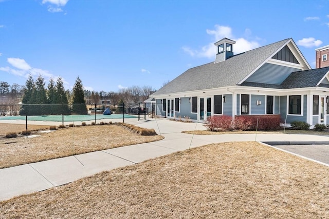 exterior space with a fenced in pool, fence, and board and batten siding