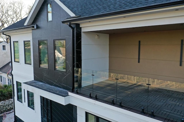 883 Greendale Ave, Needham, MA 02492 - view of property exterior featuring roof with shingles and stucco siding