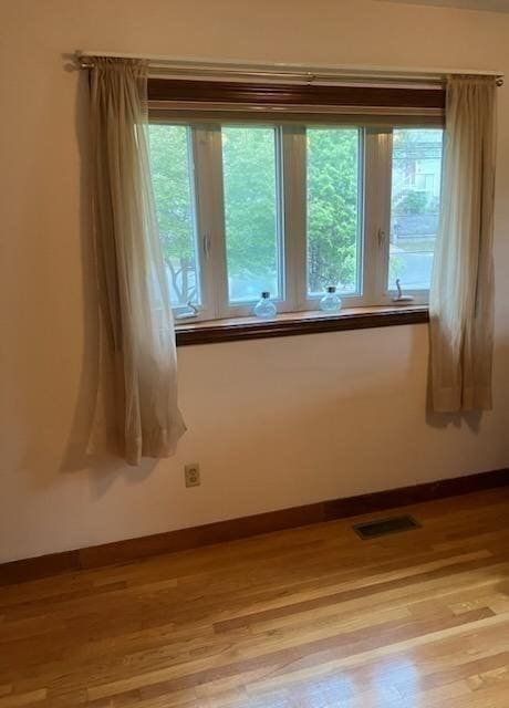 empty room with light wood-style flooring and baseboards