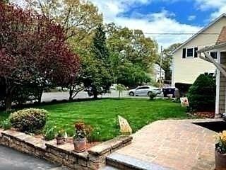 view of green lawn featuring a patio