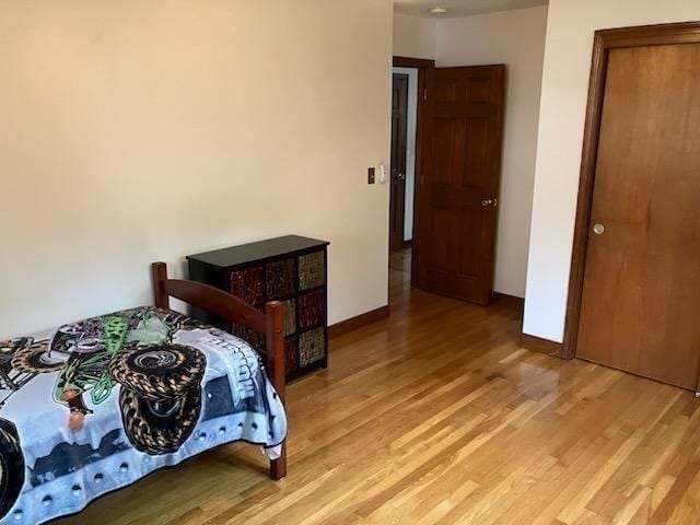 bedroom featuring light wood-style flooring and baseboards
