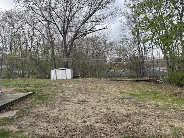 view of yard featuring a storage shed and an outbuilding