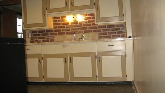 interior details with light countertops, a sink, and tasteful backsplash