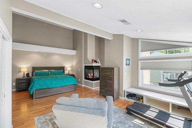 bedroom featuring recessed lighting, baseboards, visible vents, and wood finished floors