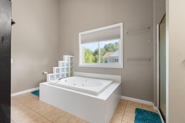 full bath with baseboards, tile patterned floors, a jetted tub, and a stall shower