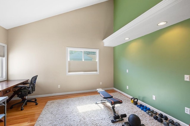 office area featuring recessed lighting, baseboards, light wood-style flooring, and a high ceiling