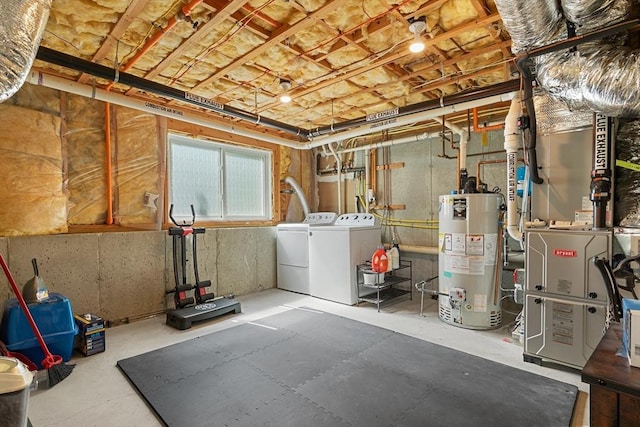 basement featuring heating unit, washer and clothes dryer, and gas water heater