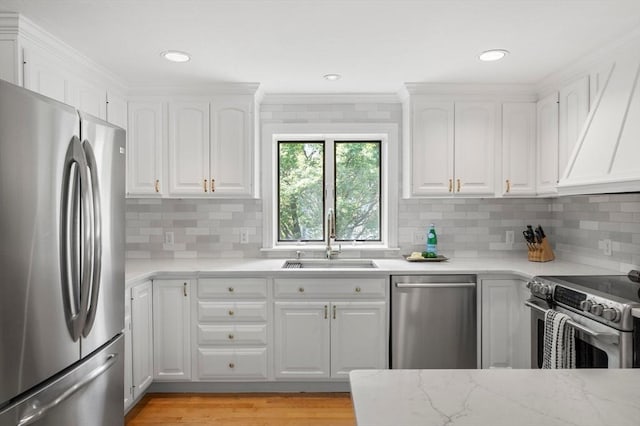 1051 Randolph Ave, Milton, MA 02186 - kitchen featuring stainless steel appliances, a sink, white cabinetry, tasteful backsplash, and crown molding