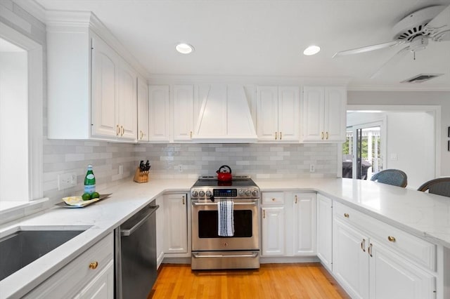 1051 Randolph Ave, Milton, MA 02186 - kitchen with appliances with stainless steel finishes, custom range hood, tasteful backsplash, light stone countertops, and white cabinets