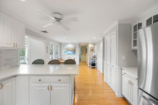 1051 Randolph Ave, Milton, MA 02186 - kitchen featuring freestanding refrigerator, ceiling fan, light wood-type flooring, ornamental molding, and glass insert cabinets